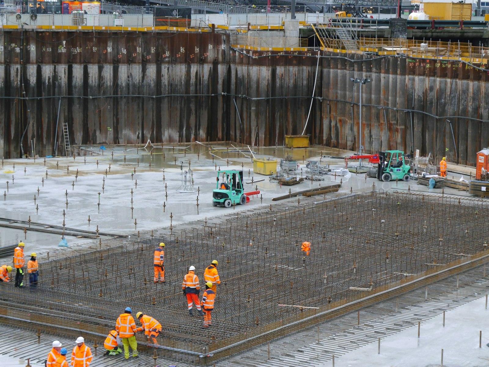 Aerial view of crews pouring a concrete foundation on a large site