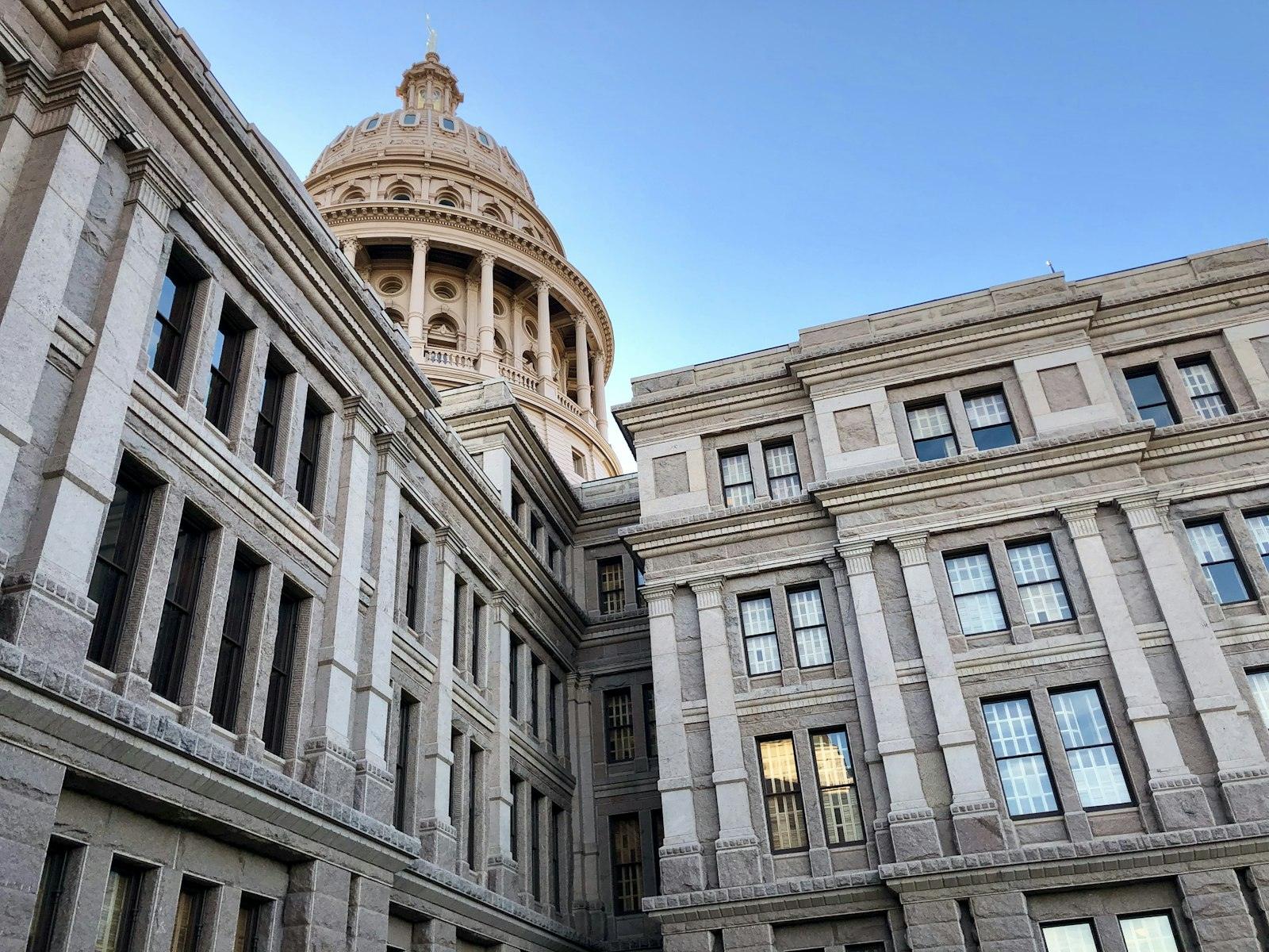 A state capitol building under a clear sky