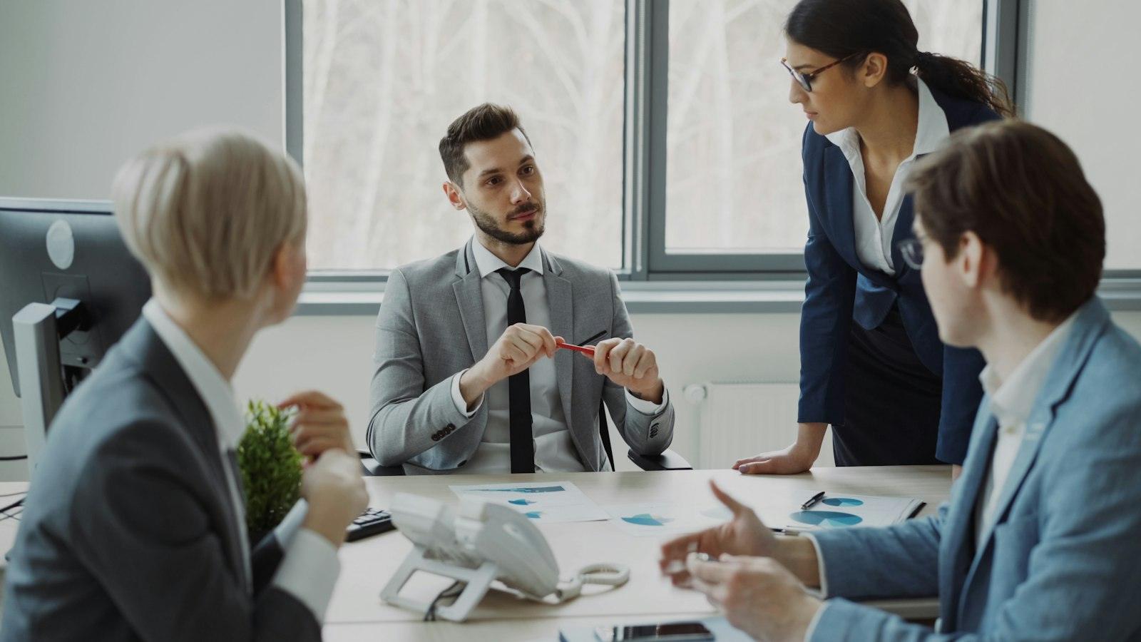 Professionals reviewing documents around a conference table
