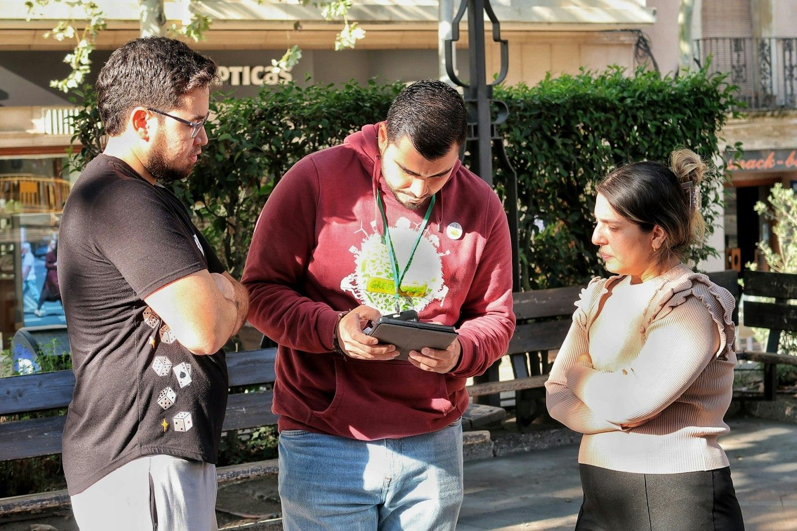 Community members reviewing information on a tablet outdoors