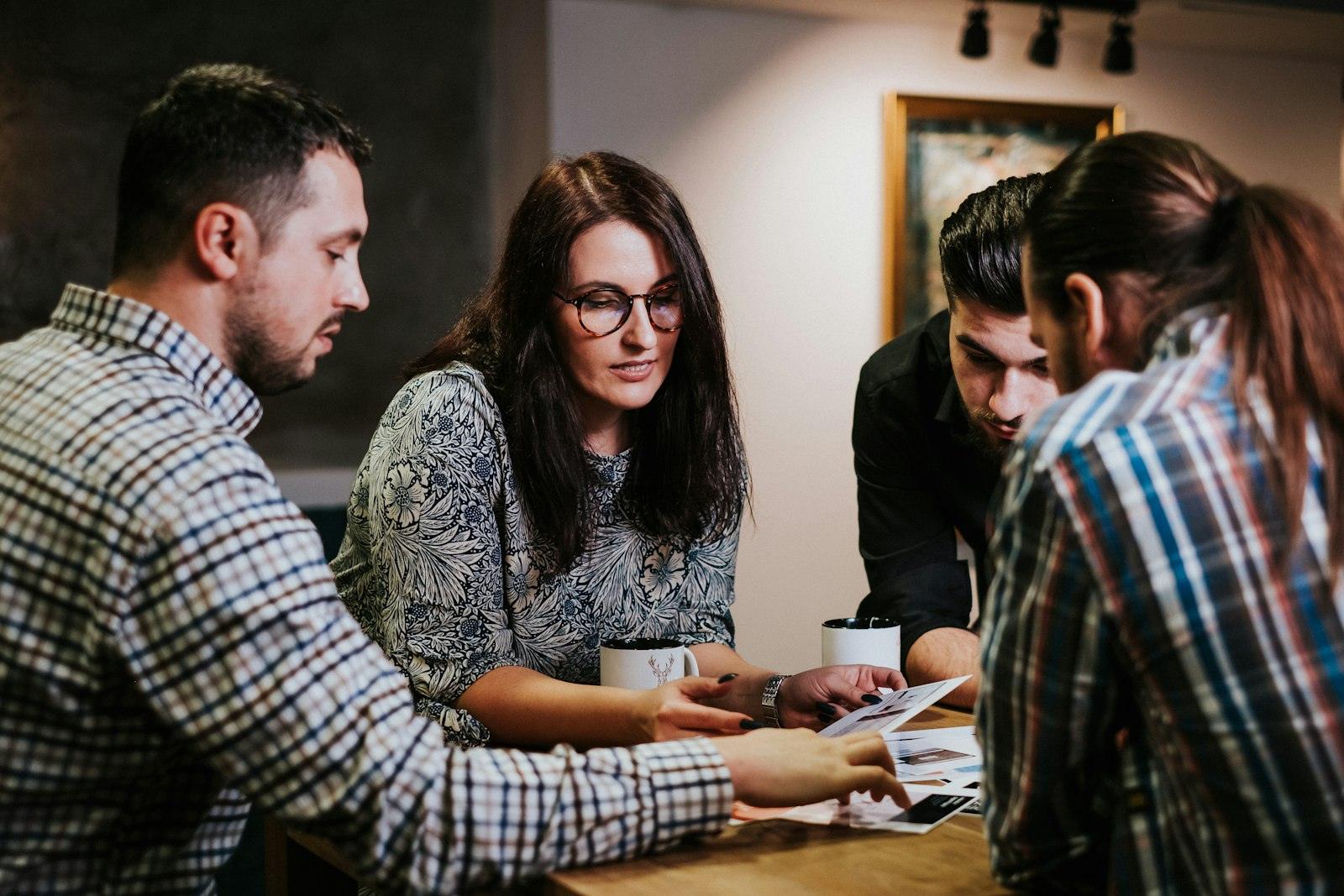 Colleagues reviewing documents together at a wooden table