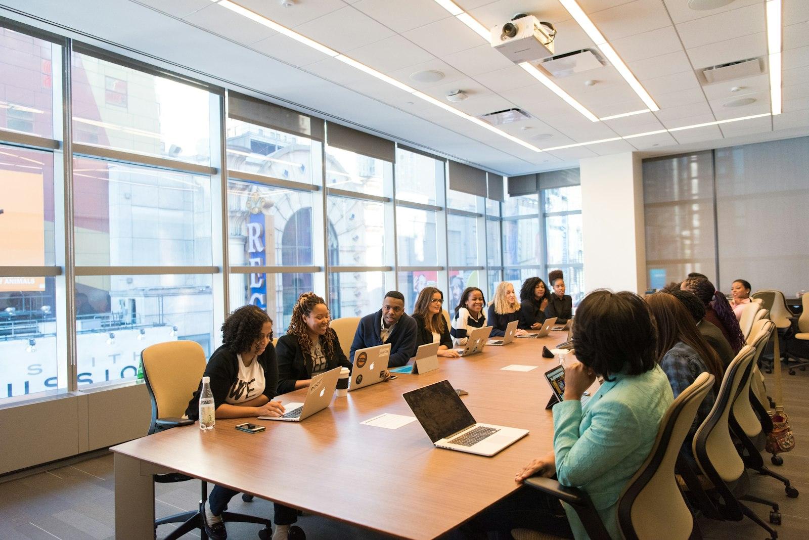 A leadership team meeting around a long conference table